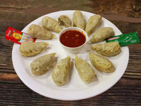 Steam Chicken Momos Served With Red Spicy Chutney Mevnies